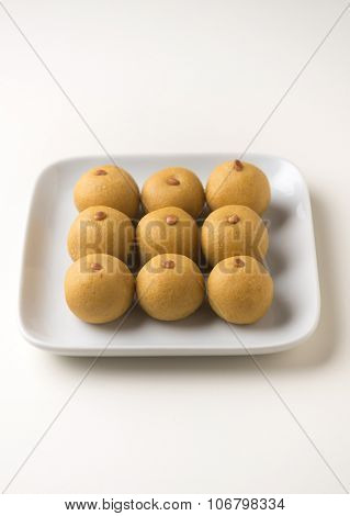 Traditional Indian recipe of Besan Ladu. Isolated plate full of Laddus.