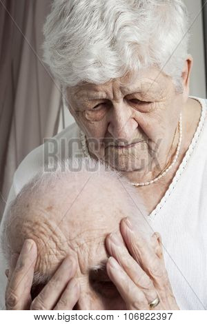 Close-up portrait of an elder couple at home