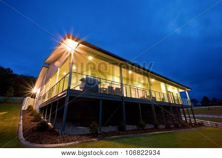 Exterior Of Lit Contemporary House At Dusk