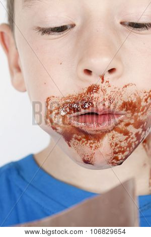 boy eat chocolate in front of a white background