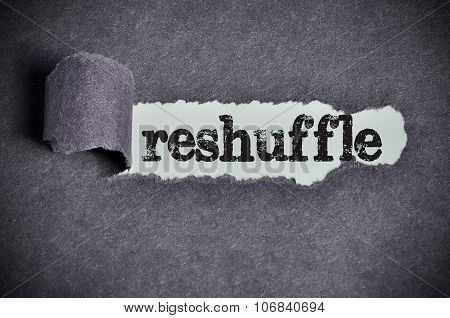 Reshuffle Word Under Torn Black Sugar Paper