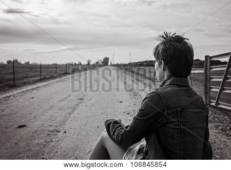 young lady sitting on suitcases