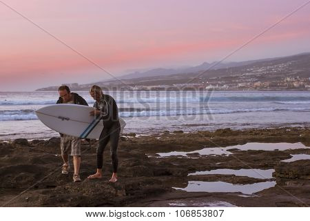 Surfers Surf On The Waves, Bright Sunset On The Coast, Tenerife, Canary Islands, Spain