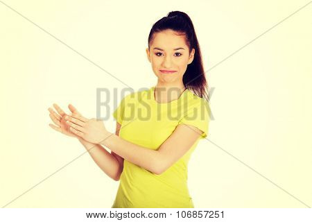 Happy teenager clapping her hands.