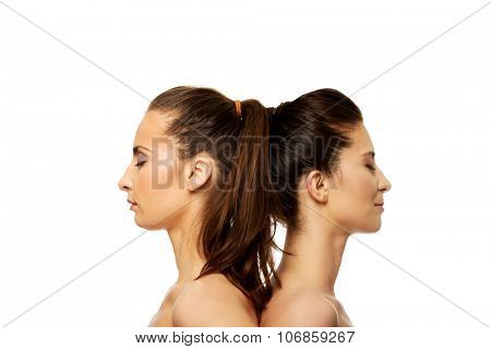 Two attractive topless sisters with make up.