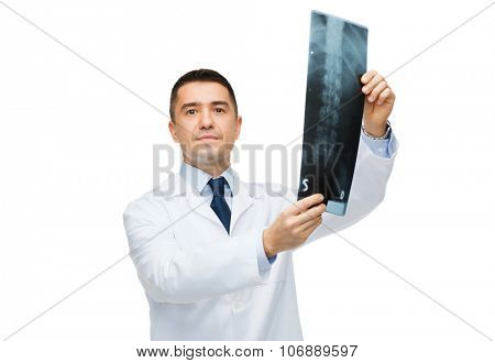 healthcare, rontgen, people and medicine concept - male doctor in white coat holding x-ray