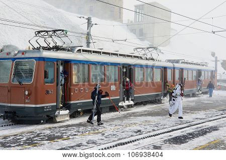 People disembark from the train at the upper Gornergratbahn railway station in Zermatt, Switzerland.