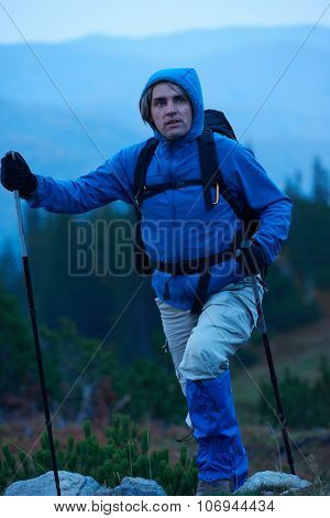 advanture man with backpack hiking on mountain forest