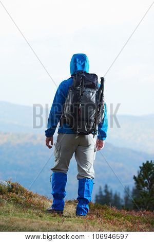 advanture man with backpack hiking on mountain forest