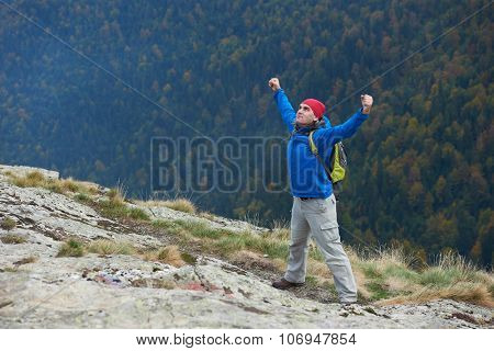 advanture man with backpack hiking on mountain forest