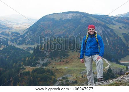 advanture man with backpack hiking on mountain forest