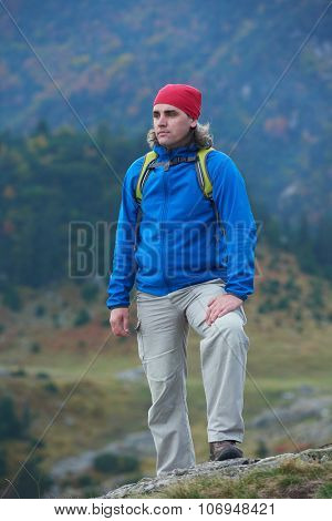 advanture man with backpack hiking on mountain forest