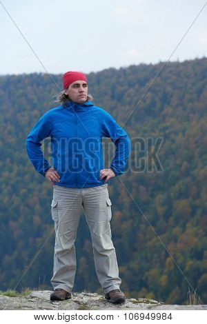 advanture man with backpack hiking on mountain forest