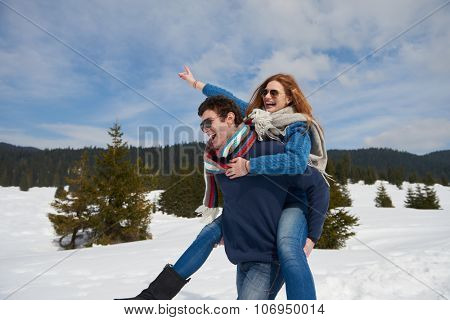 romantic winter  scene, happy young couple having fun on fresh show on winter vacatio, mountain nature landscape