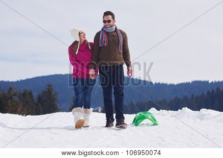 romantic winter  scene, happy young couple having fun on fresh show on winter vacatio, mountain nature landscape