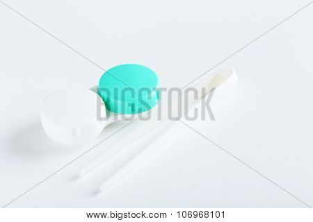 Contact Lenses In Container With Solution On White Background