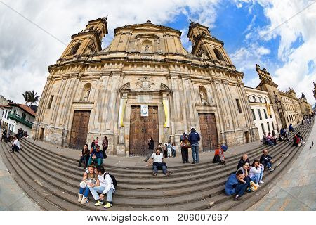 BOGOTA COLOMBIA - APRIL 23: Unidentified people relax in front of the primary cathedtral in Bolivar Square on April 23 2016 in Bogota Colombia.
