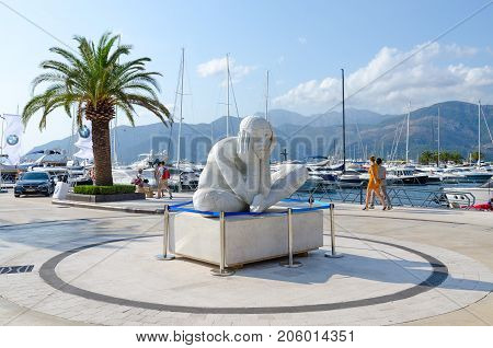 TIVAT MONTENEGRO - SEPTEMBER 10 2017: Sculpture near elite yacht club Porto Montenegro in popular resort town of Tivat Montenegro. Unidentified people are strolling along promenade