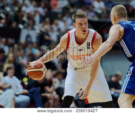 ST. PETERSBURG, RUSSIA - AUGUST 4, 2017: Dmitry Kulagin in action in the basketball match Russia (white) vs Finland (blue) during Kondrashin-Belov Cup. Russia won 91:75