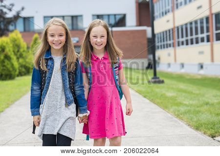 The Great Portrait Of School Pupil Outside Classroom Carrying Bags
