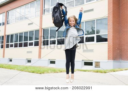 The Great Portrait Of School Pupil Outside Classroom Carrying Bags