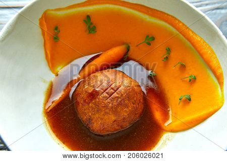 Dumpling of old cowtail with creamy carrot and its juice