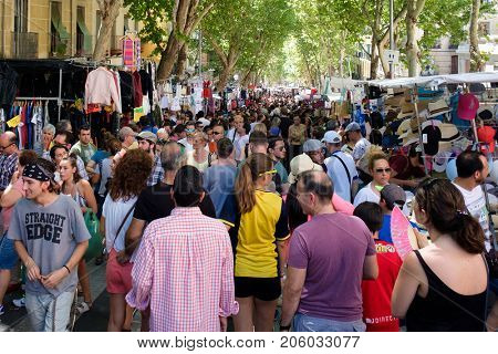 MADRID,SPAIN - AUGUST 6,2017 : People shopping at El Rastro, the most popular open air market in Madrid