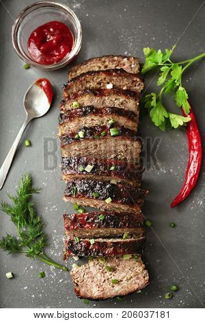 Tasty sliced turkey meatloaf on baking tray