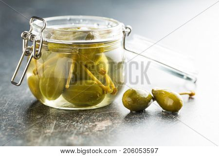 Pickled caper berries in jar.
