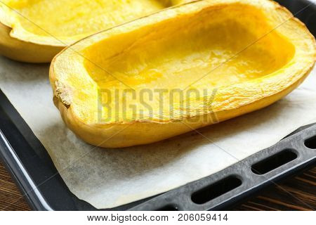 Baked halves of spaghetti squash on baking sheet