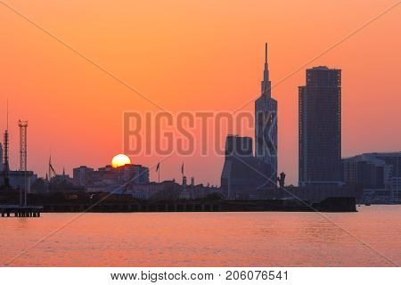 View from Sea Beach to sityscape with Skyscrapers And Tower at sunset, Batumi, Adjara, Georgia