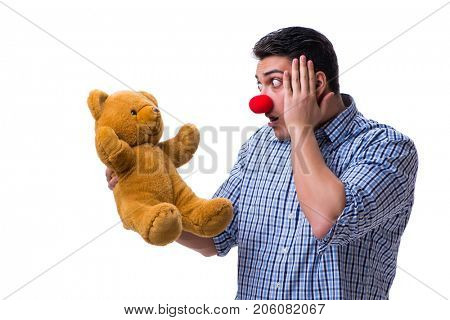 Funny clown man with a soft teddy bear toy isolated on white bac
