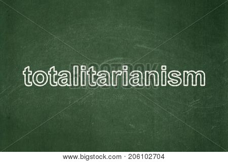 Politics concept: text Totalitarianism on Green chalkboard background