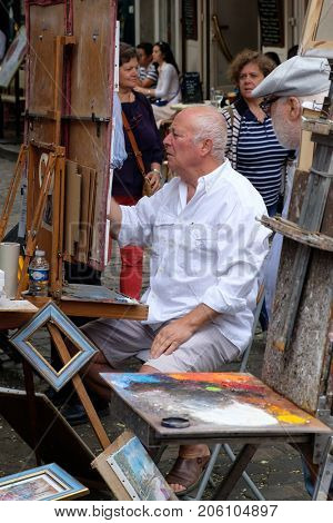 PARIS,FRANCE - JULY 31,2017 : Painter at the Place du Tertre in the historic district of Montmartre