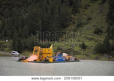 Logistics Ferryboat Floating In Kaunertaler Glacier Lake And Dam In Kaunergrat Nature Park