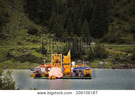 Logistics Ferryboat Floating In Kaunertaler Glacier Lake And Dam In Kaunergrat Nature Park