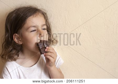 The girl inhales the favorite smell of her milk chocolate