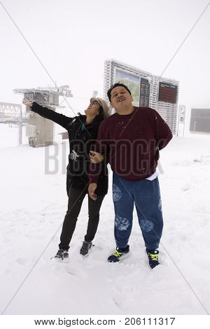 Thai people husband and wife travel and portrait at top of mountain in Kaunergrat nature park while snowing covered on floor on September 3 2017 in Tyrol Austria