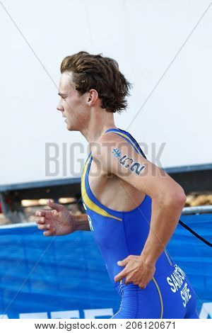 STOCKHOLM - AUG 26 2017: Side view of running triathlete Gabriel Sandor (SWE) in the Men's ITU World Triathlon series event August 26 2017 in Stockholm Sweden
