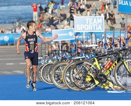 STOCKHOLM - AUG 26 2017: Running triathletes Jonathan Brownlee realize he is going to win the race in the Men's ITU World Triathlon series event August 26 2017 in Stockholm Sweden