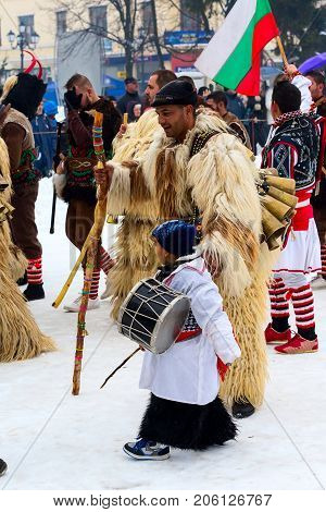 Razlog, Bulgaria - January 14, 2017: People in traditional carnival kuker costumes at Kukeri festival Starchevata