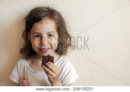 A child in anticipation of a sweet dessert. Chocolate in hand gourmet smile