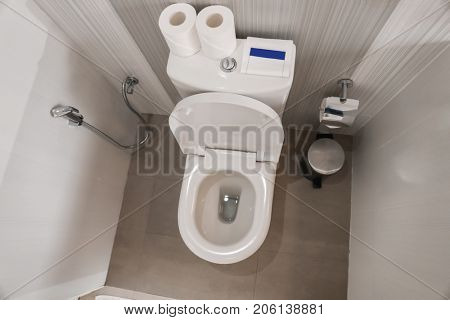 Toilet bowl in modern restroom