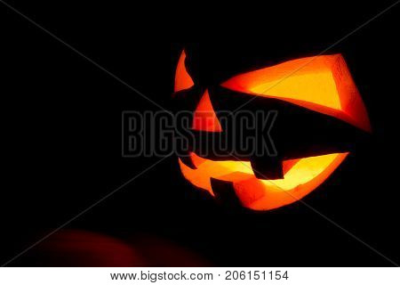 The Concept Of Halloween. The Ghastly, Ghastly Pumpkin Glows With A Fiery Yellow Light. Mystical Jac