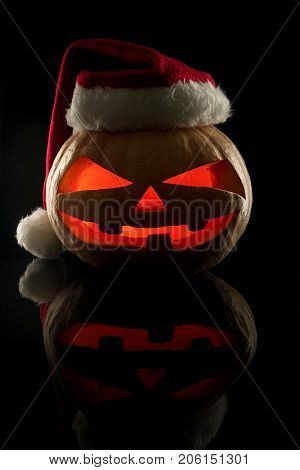 The Concept Of Halloween And The New Year And Christmas. The Evil Scary Pumpkin Santa In The Santa C
