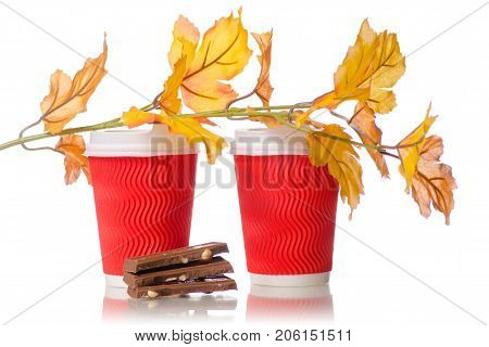 Two cardboard coffee cups chocolate yellow leaves on a white background isolation