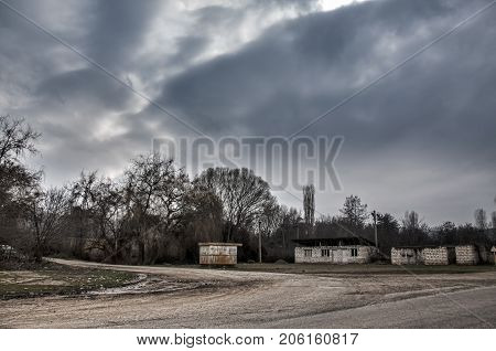 Ground Road In Village In Winter Countryside The Evening Sunlight. Atmospheric Rural Moment. Old Hou