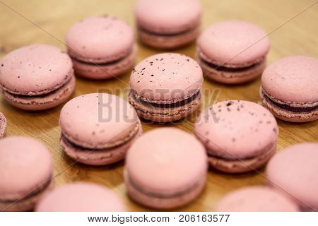 cooking, confectionery and baking concept - macarons on table