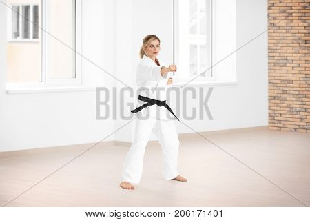 Female karate instructor training in dojo