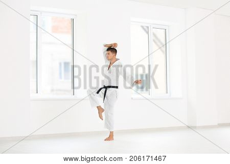 Male karate instructor training in dojo